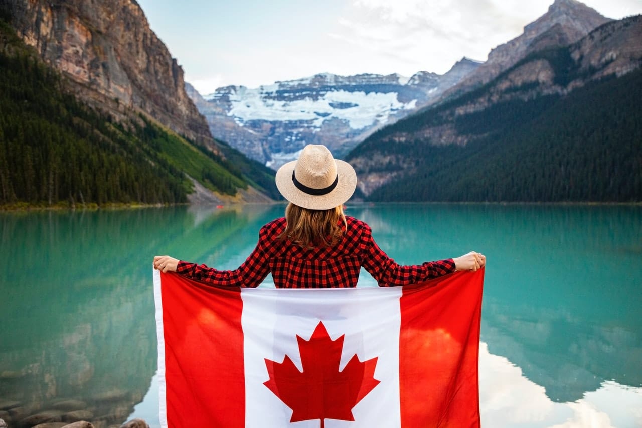 a young girl covered with a Canadian flag