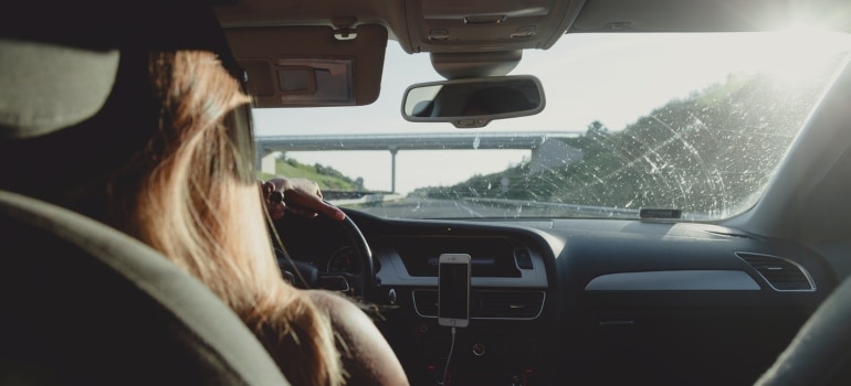 a woman driving a car on the highway