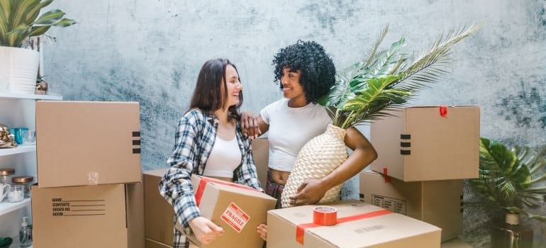 two women smiling after moving with long-distance moving companies Winnipeg