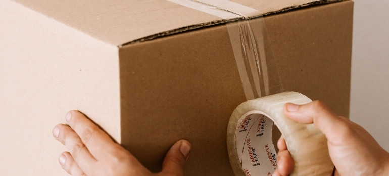 person packing a box