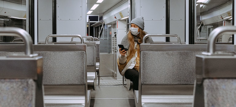 Woman Wearing Mask on Train thinking when is the best time to buy a house in Ontario