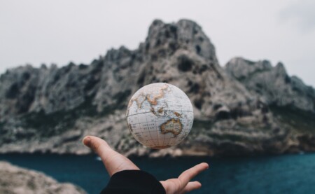 person holding a small globe