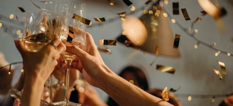 people toasting for New Year's resolution tips for moving