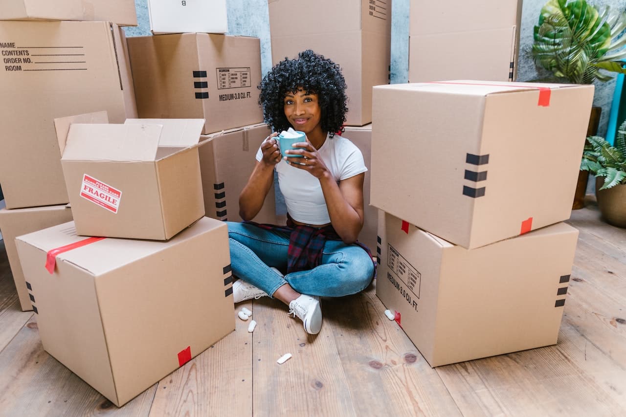 A woman sitting in front of boxes
