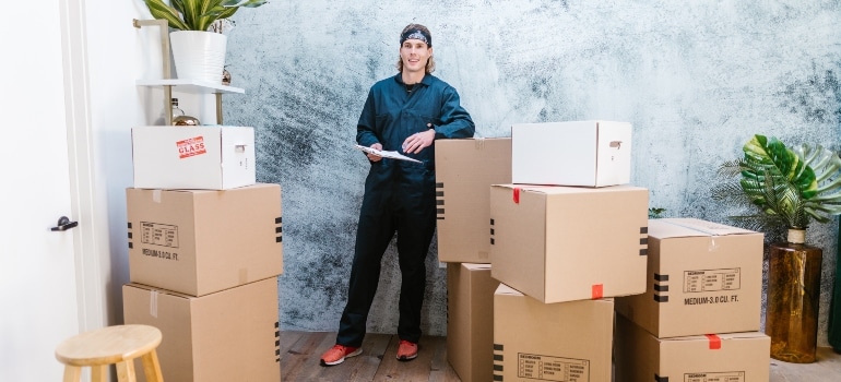 A man surrounded by moving boxes