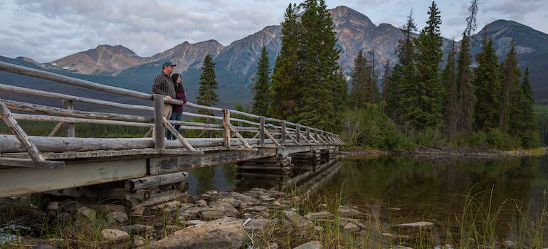 a couple on a bridge, talking about the Benefits of living in Saskatchewan