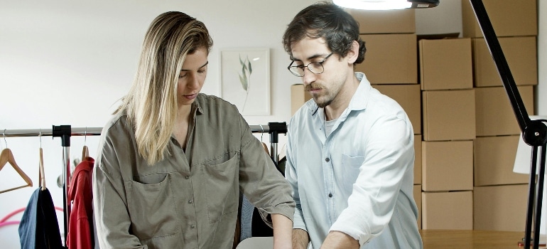 Man and Woman Wrapping Product on the Table