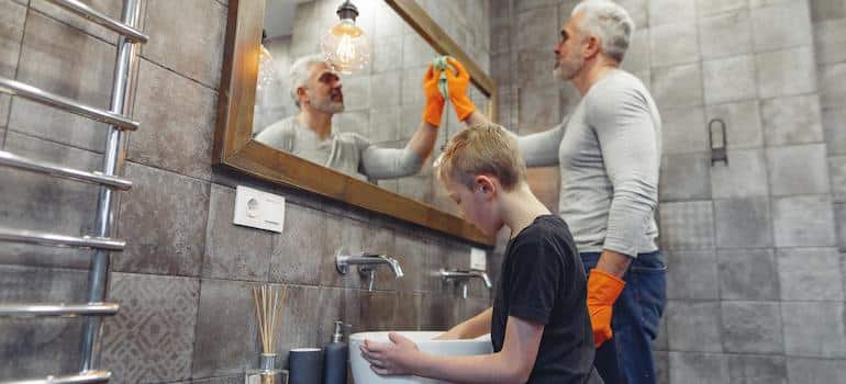father and his son cleaning the bathroom