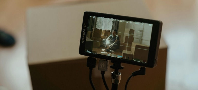 A person filming another person on an iphone.