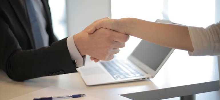 two people shaking their hands