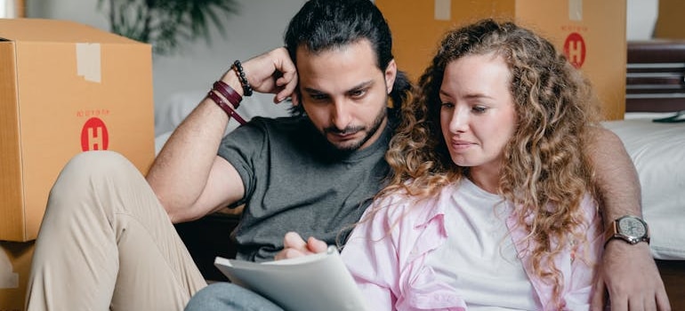 a couple checking their plans after they settle In after moving from Medicine Hat to Ottawa