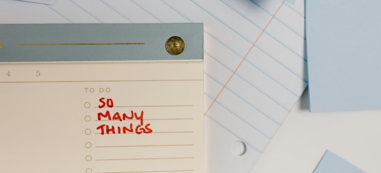 Handwritten note on a task sheet reading “SO MANY THINGS”—perfect visual for a checklist for moving to Edmonton.