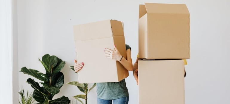 Couple carrying boxes