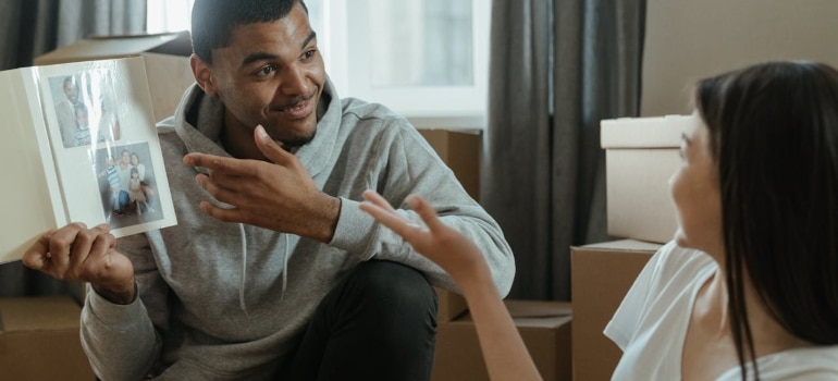 Couple looking at photos while unpacking