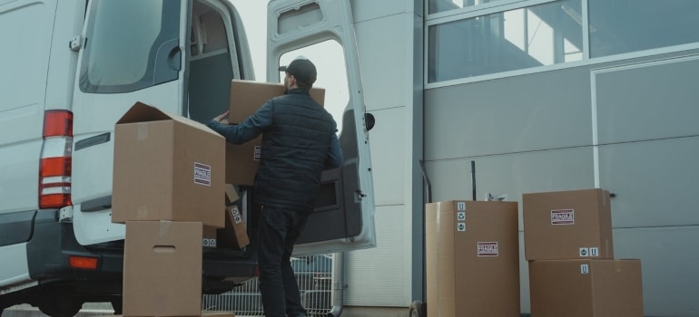Person loading boxes into a van