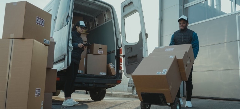 People loading boxes in a van