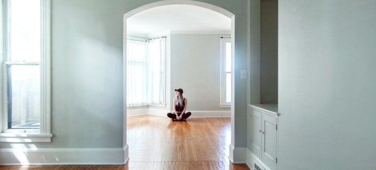 Person sitting in an empty home after moving to Kitchener