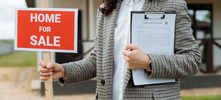 Person holding a red sign
