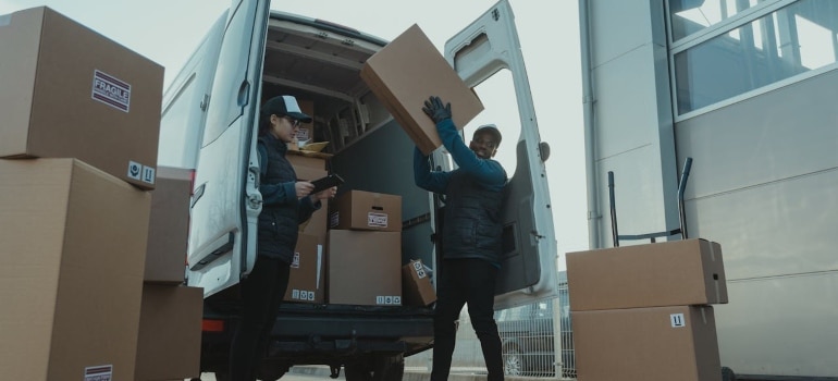 People packing boxes into a van for moving from Toronto to Vancouver